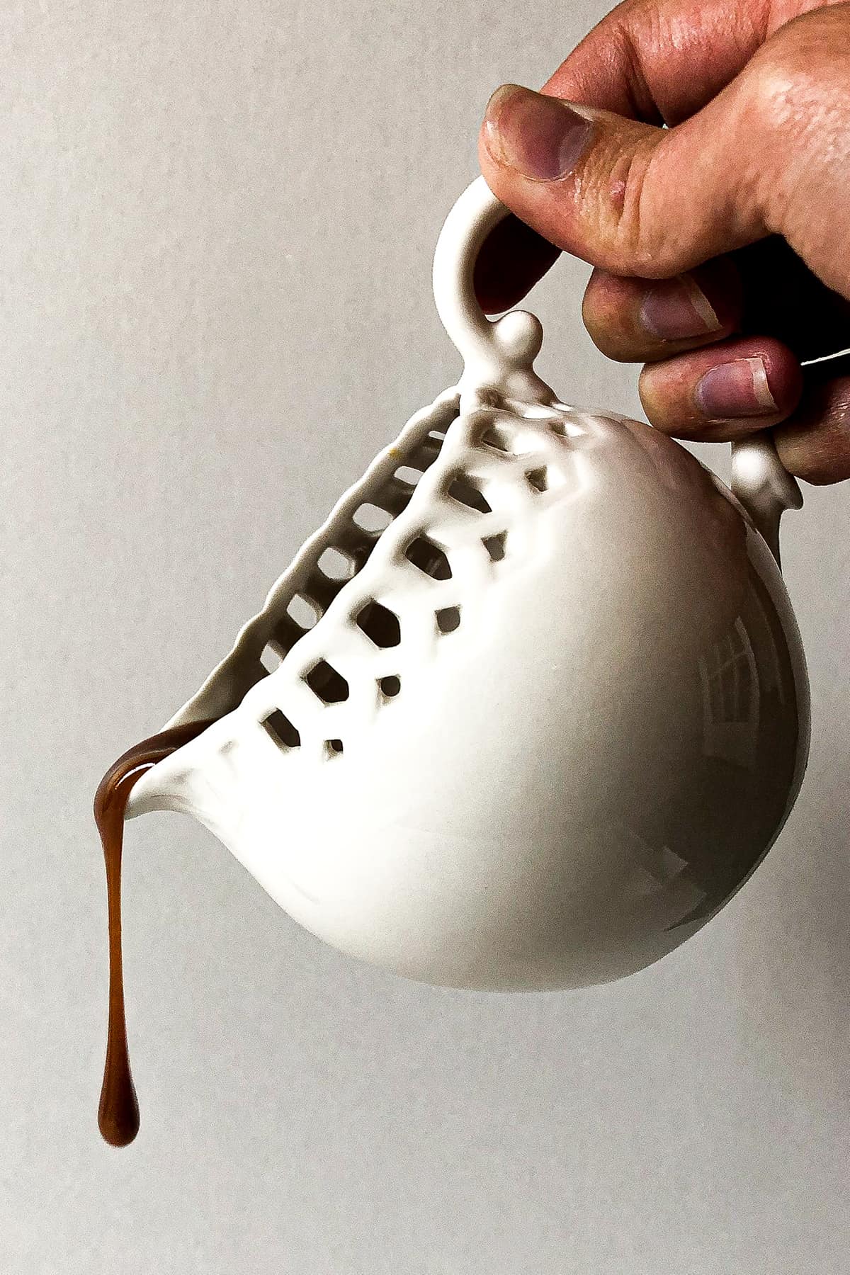 Salted caramel being poured out of a cup.