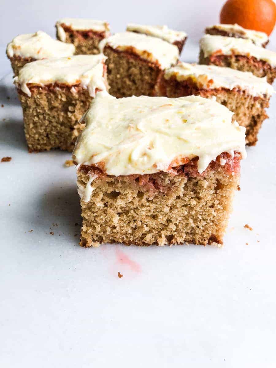 brandy old fashioned cake piece from the side with orange zest frosting.