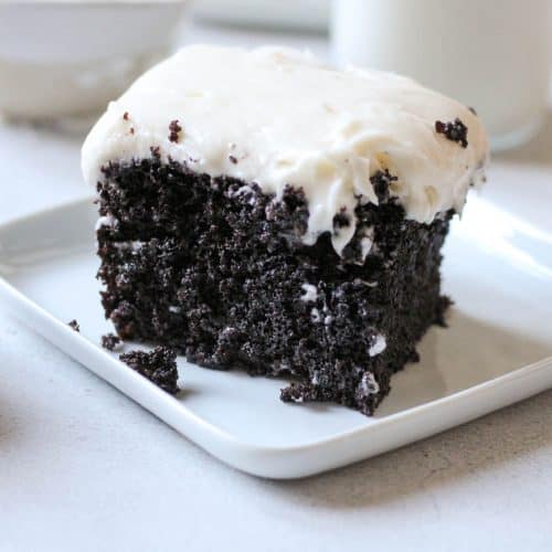 slice of chocolate cake with vanilla cream cheese frosting