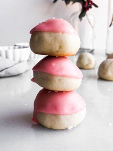 Maraschino cherry cookies stacked on top of each other.